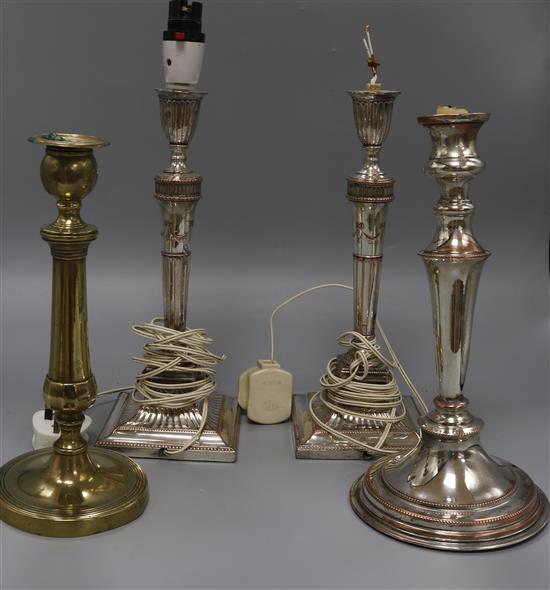 Four plated candlesticks, one fitted as a table lamp